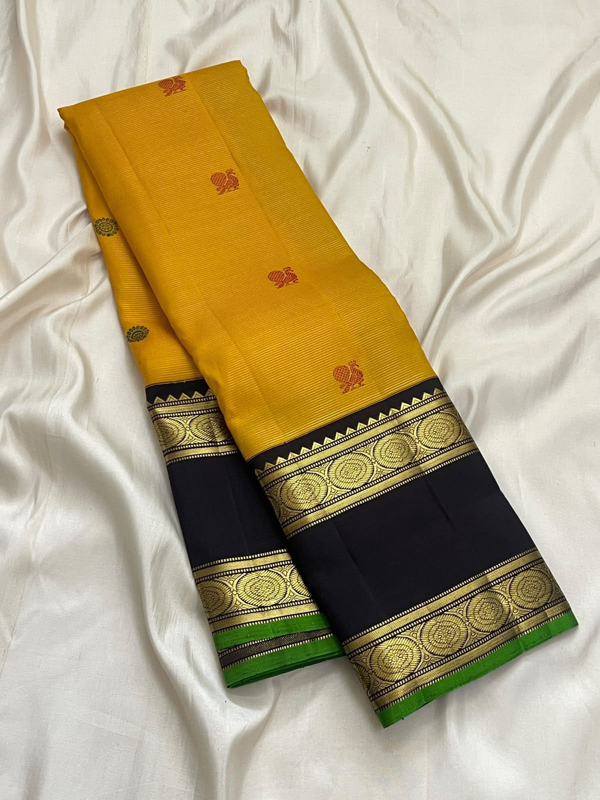 Turmeric Yellow Handwoven Pure Silk Kanchipuram Saree with Rettapet Border and Mayil Chakram, folded saree presentation