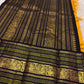 Turmeric yellow Kanjeevaram silk saree with deep navy Varisaipet border, full view