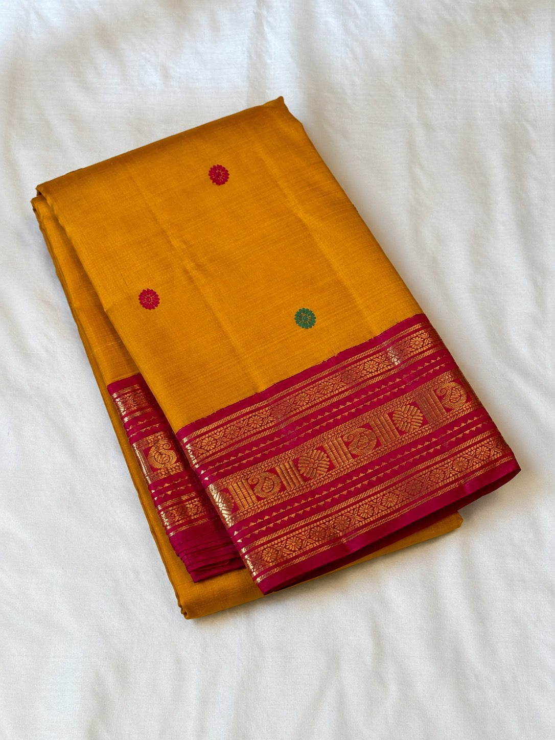 Turmeric yellow Kanjeevaram silk saree with Maanga zari border detail