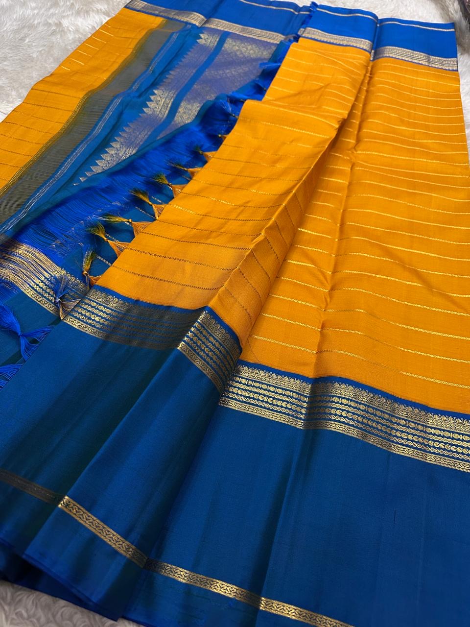 Turmeric Yellow Kanjivaram saree with horizontal gold zari Veldhari lines