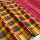 Turmeric yellow Kanjivaram pure silk saree antique gold zari border closeup