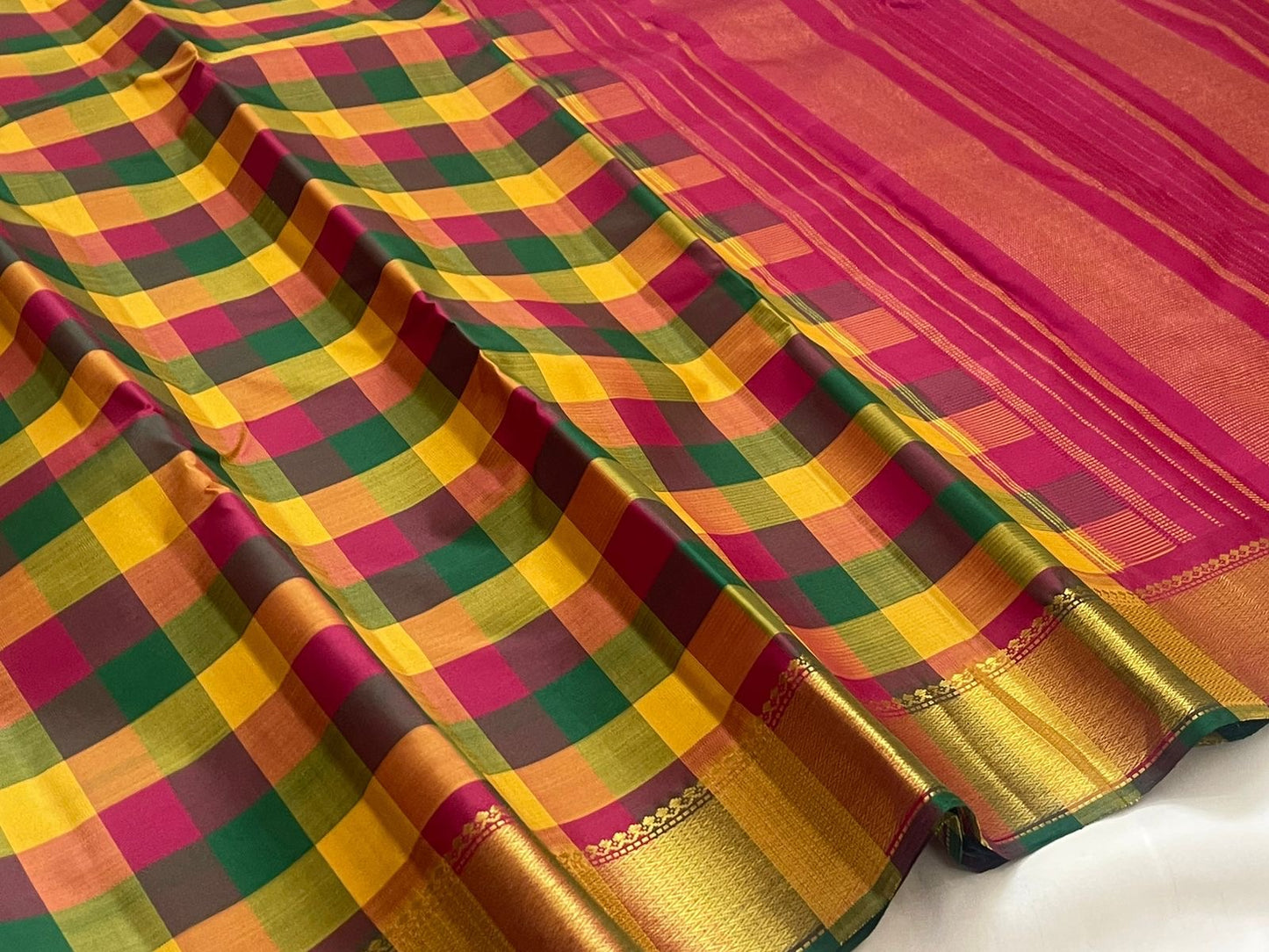 Turmeric yellow Kanjivaram pure silk saree antique gold zari border closeup