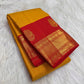 Turmeric Yellow Pure Silk Kanchipuram Butta saree with fine vertical zari lines.