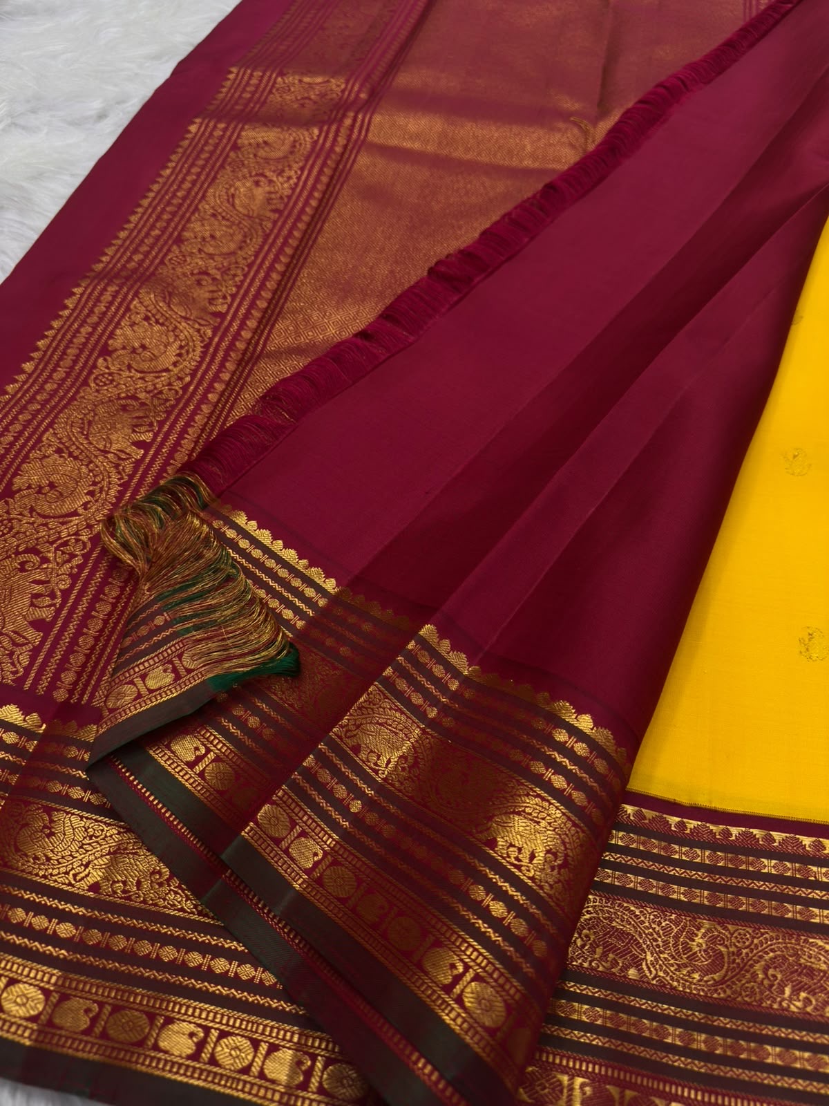 Turmeric-yellow body against Arakku red border, Kancheepuram Korvai saree