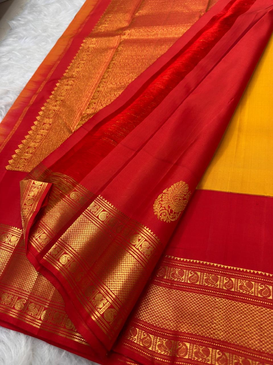 Turmeric Yellow and Vermilion Red Kanchipuram Butta saree.