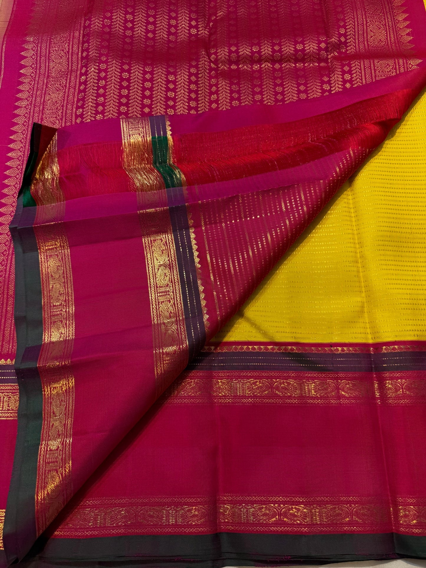 Turmeric Yellow Kanchipuram silk saree with fine antique-gold linear zari detailing.