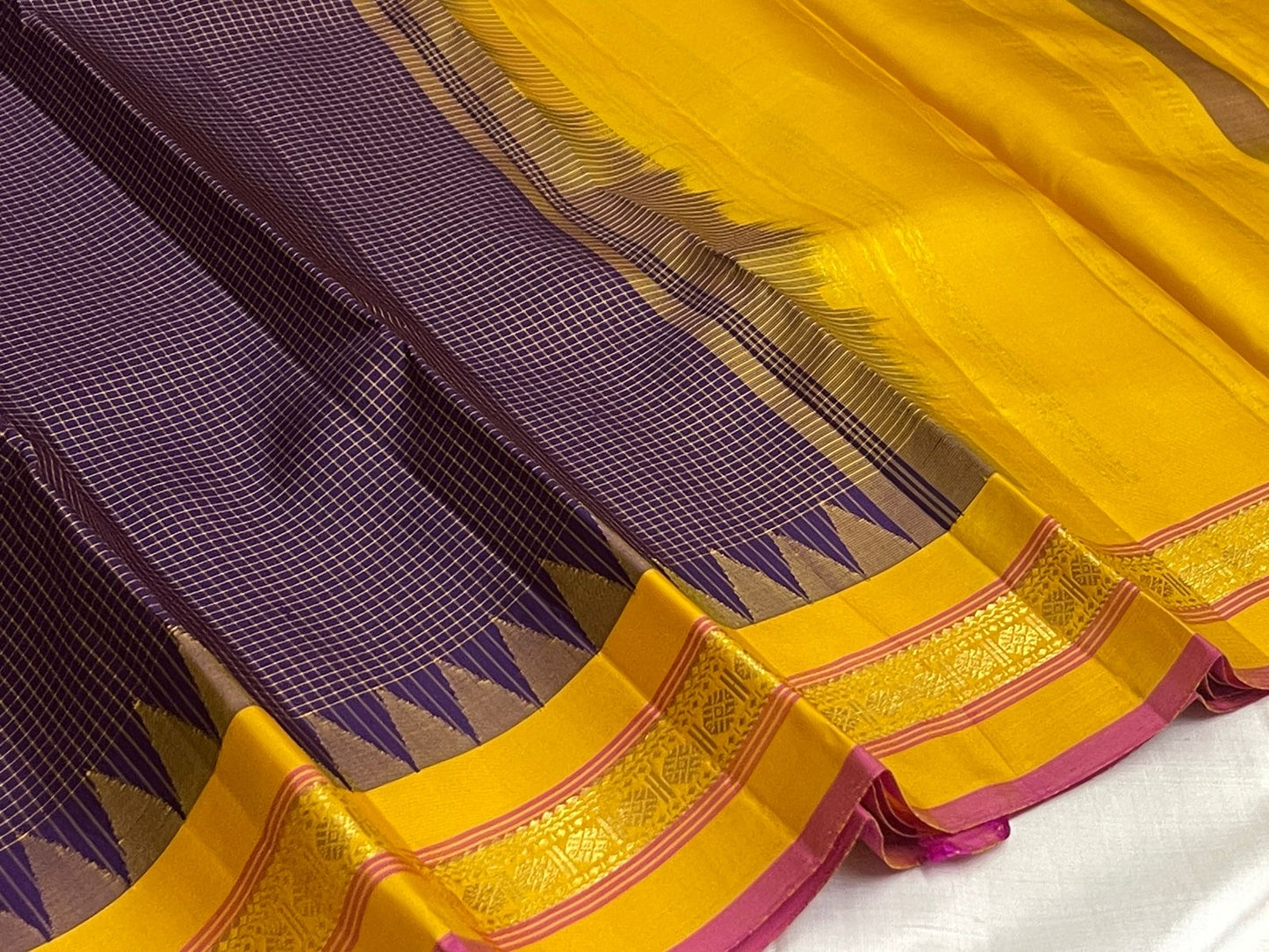 Turmeric Yellow border with temple-inspired pointed zari forms rising from the Deep Purple body
