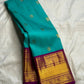 Turquoise Blue Pure Silk Kanchipuram Korvai saree with scattered gold zari buttas and Deep Purple ornamental zari border.