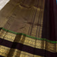 Handwoven pure silk Kancheepuram rettapet saree in turquoise blue with larger gold buttas and a coffee-brown contrast border.