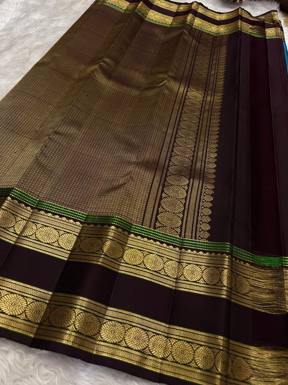 Handwoven pure silk Kancheepuram rettapet saree in turquoise blue with larger gold buttas and a coffee-brown contrast border.