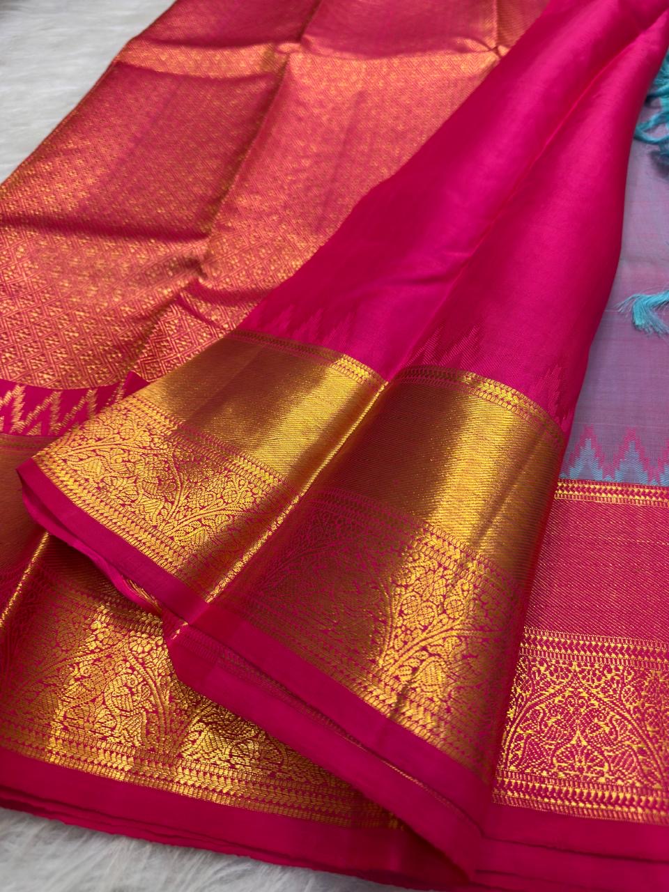 Turquoise blue body detail showing repeating gold zari buttas.