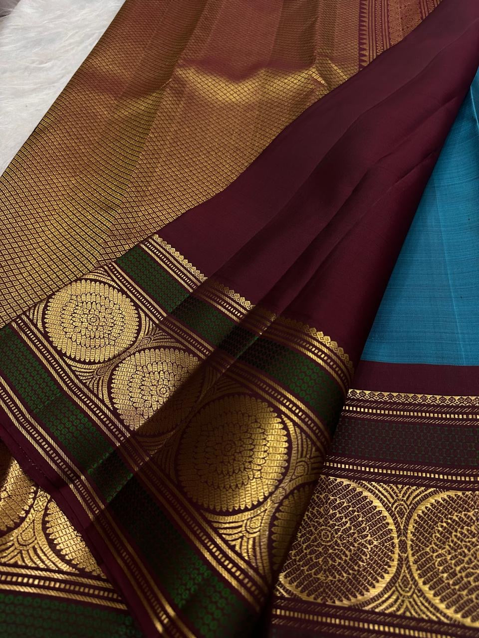 Turquoise Blue Pure Silk Kanchipuram Butta saree with grand Kamalam gold zari border