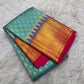 Turquoise blue and fuchsia pink contrast on the Kanchipuram silk saree.