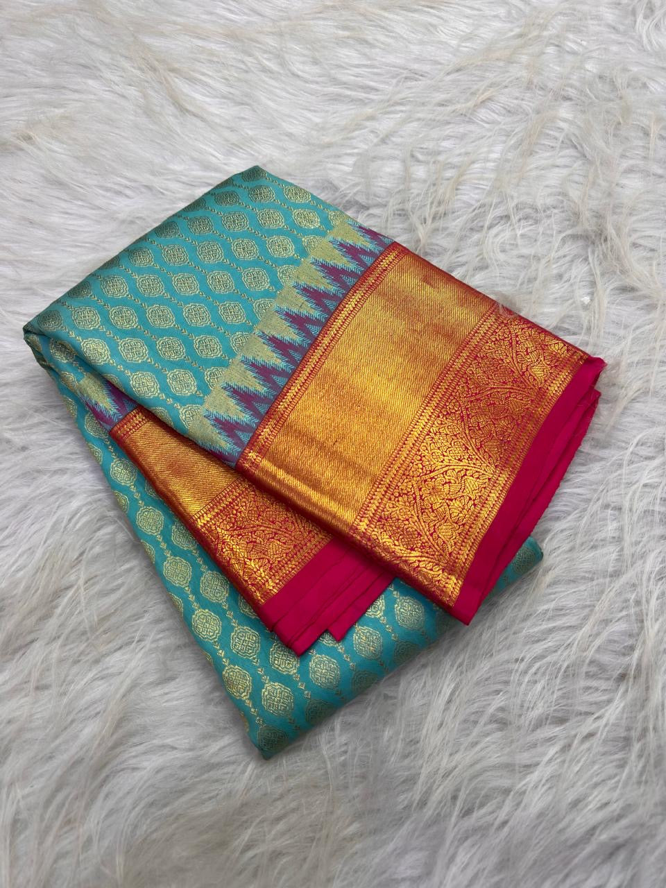Turquoise blue and fuchsia pink contrast on the Kanchipuram silk saree.