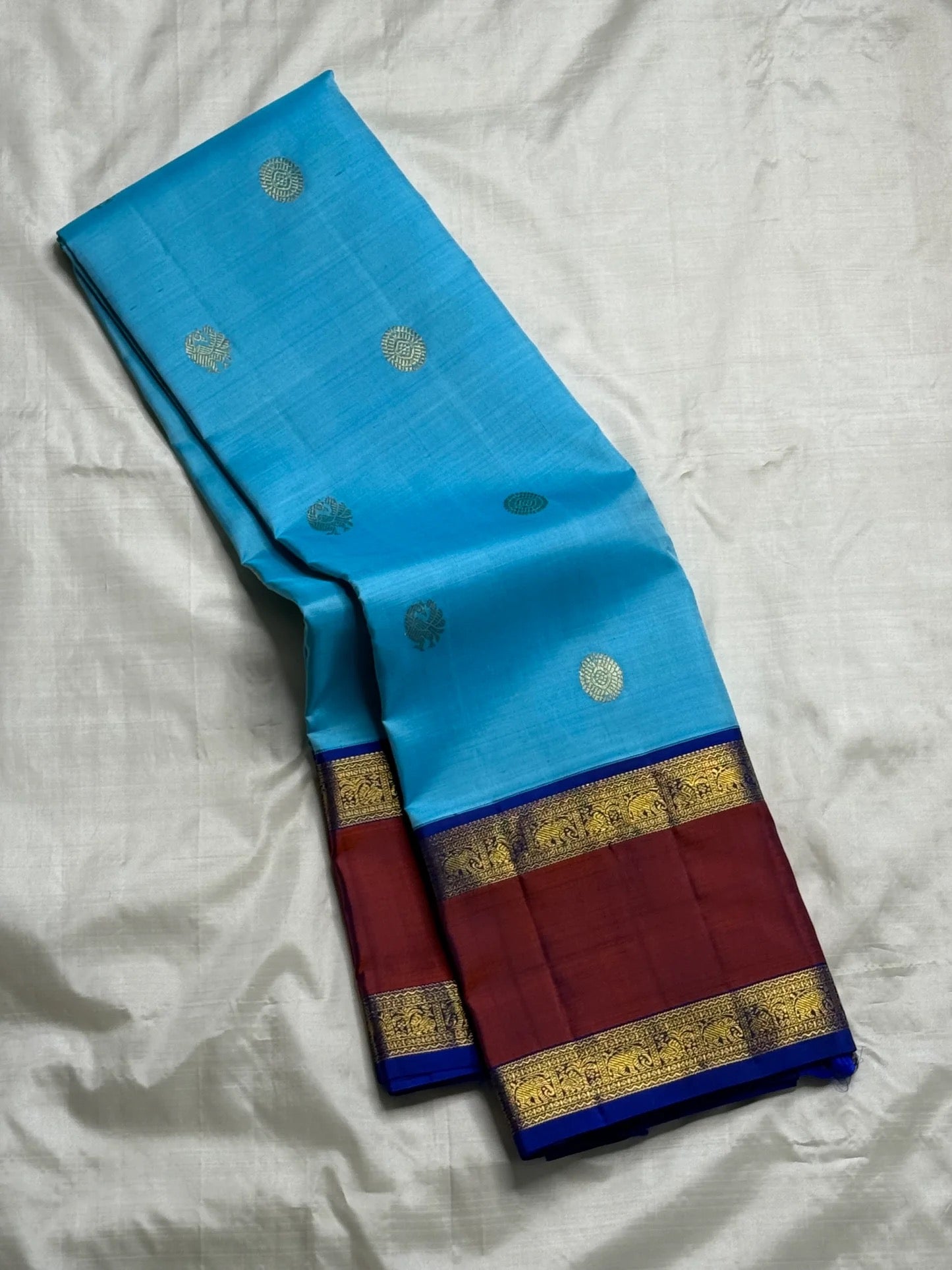Turquoise blue pure silk Kanjipuram Rettapet saree with Aadum Mayil zari motifs, full drape view