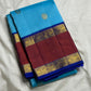 Close-up of Aadum Mayil and Chakram zari buttas on turquoise blue Kanjipuram silk saree