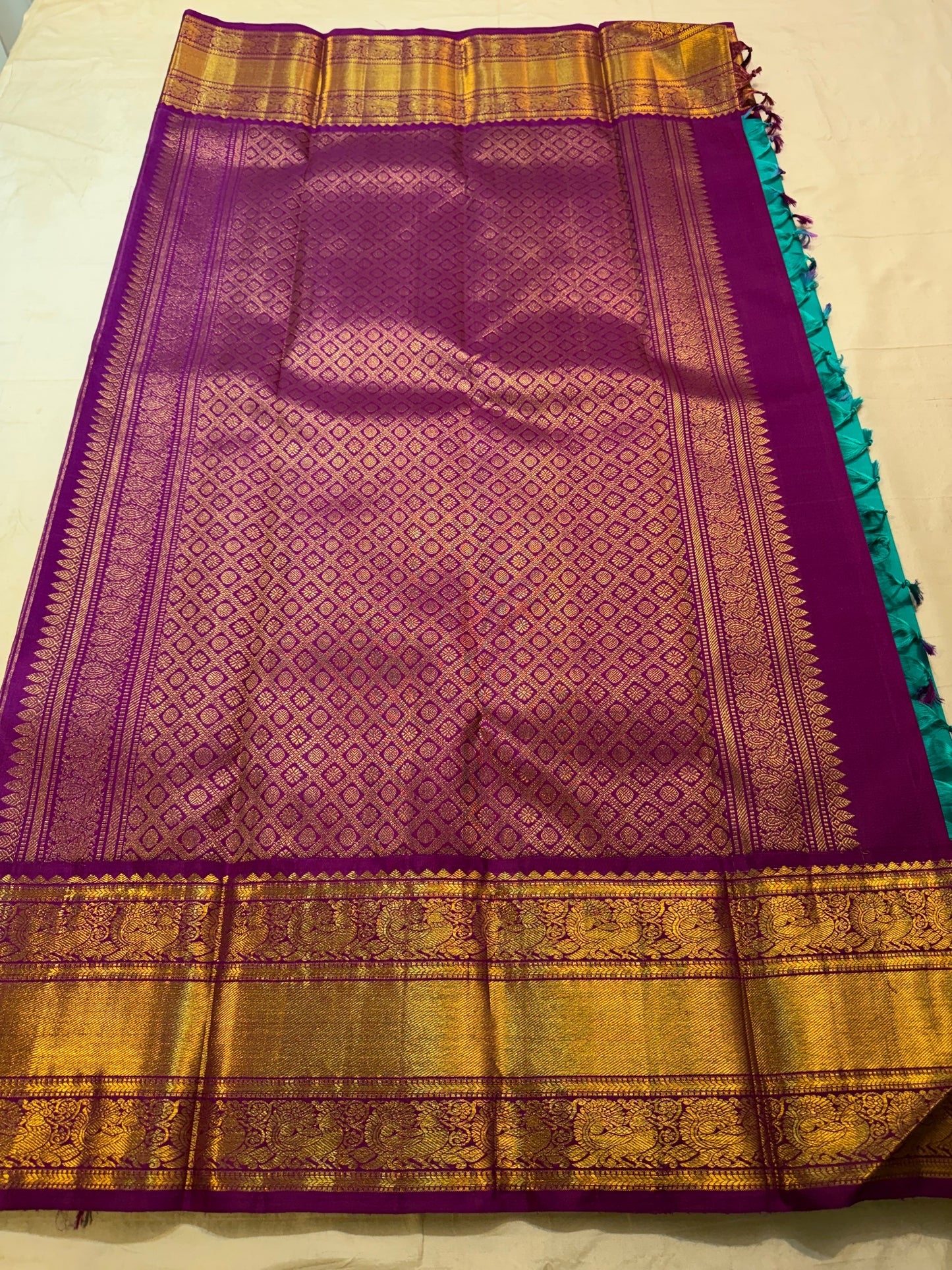 Deep Purple and gold Korvai pallu showing geometric zari lattice, ornamental registers and Turquoise Blue Kanchipuram silk.
