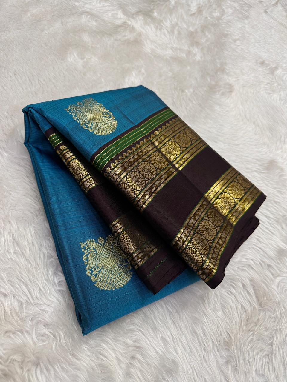 Turquoise blue body detail showing larger gold zari buttas.