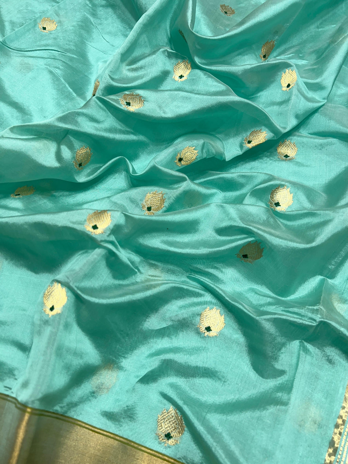 Aqua Blue Chanderi silk saree pallu showing the broad pale metallic woven field with fine textural patterning