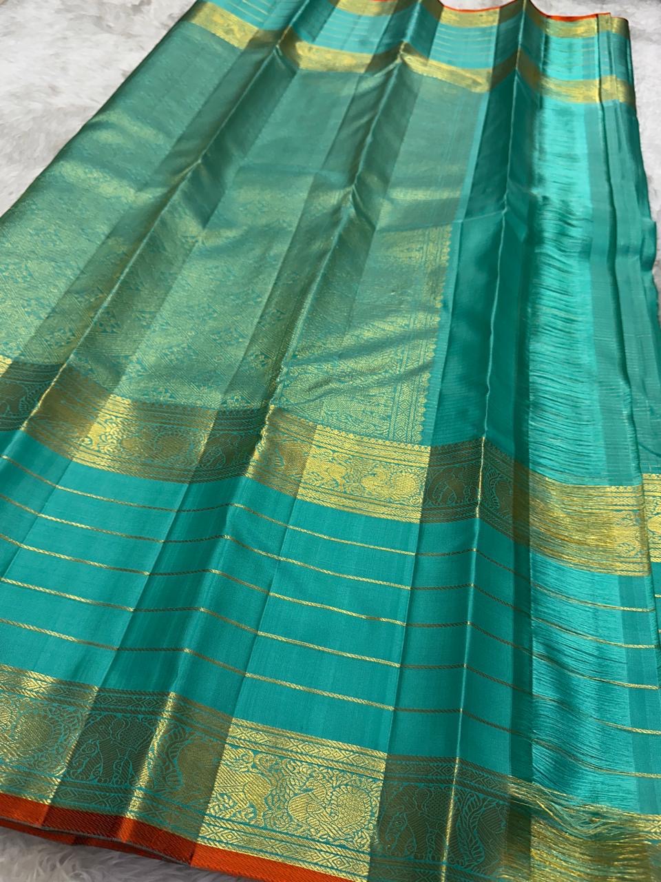 Handwoven Sea Green Varisaipet saree with layered antique-gold traditional border.