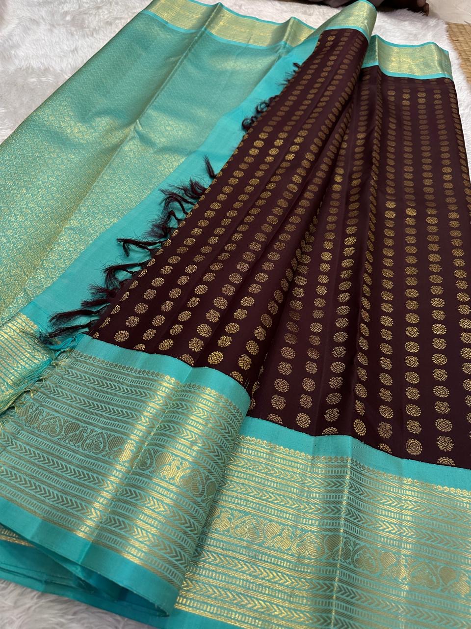 Turquoise zari border with fine chevrons, geometric bands and repeating ornamental motifs.