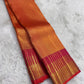 Radiant orange dense Ettukol Kancheepuram silk saree with broad Vadamalli gold border