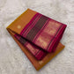 Pure silk mustard Butta saree showing evenly spaced circular floral gold zari motifs