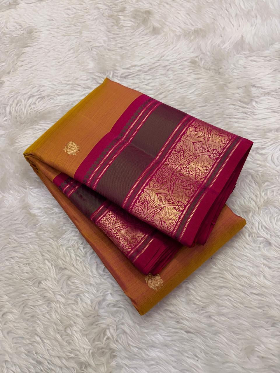 Pure silk mustard Butta saree showing evenly spaced circular floral gold zari motifs