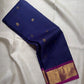 Vadamalli magenta-purple pallu with multiple warm gold zari bands and traditional ornamental motifs.