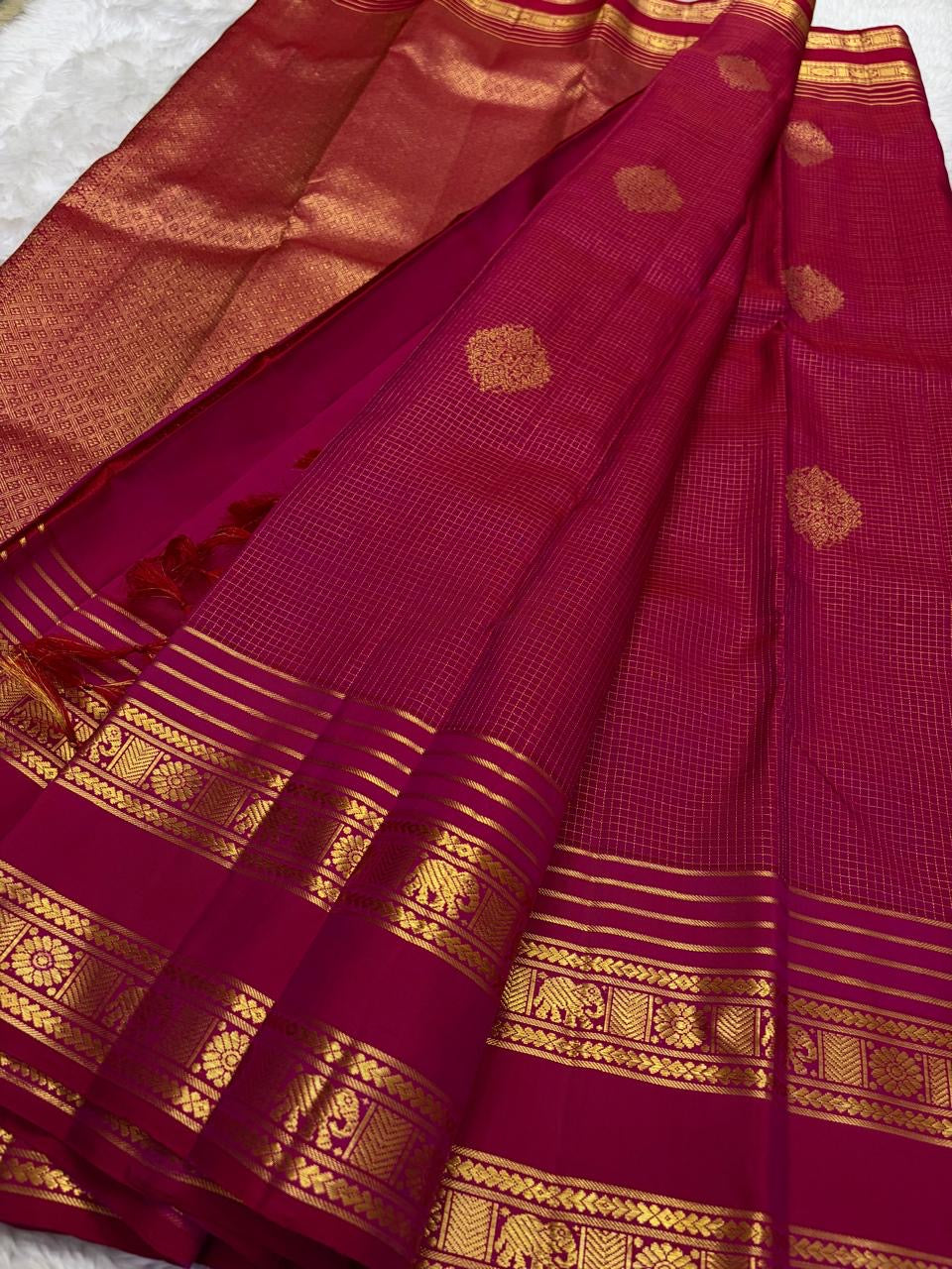 Close view of antique-gold checked zari grid on Pomegranate Pink Kanjivaram silk.