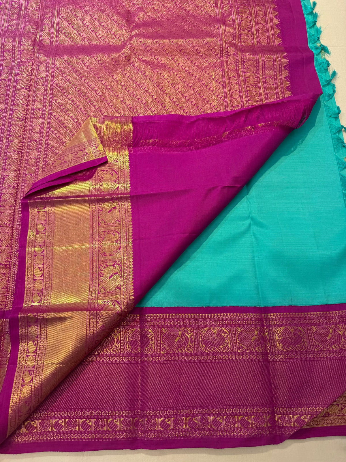 Jewel-toned magenta-pink and teal pure silk Kanchipuram saree with luminous gold zari