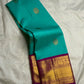 Vadamalli magenta-pink Vairaoosi Kanchipuram silk saree with teal contrast zari border and pallu