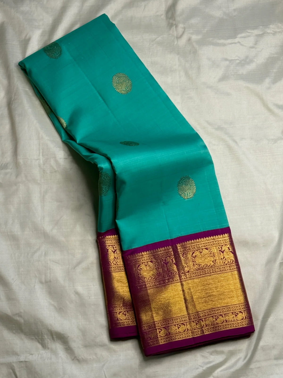 Vadamalli magenta-pink Vairaoosi Kanchipuram silk saree with teal contrast zari border and pallu