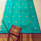 Broad teal blue-green border with dense gold zari, geometric details and stylised bird motifs