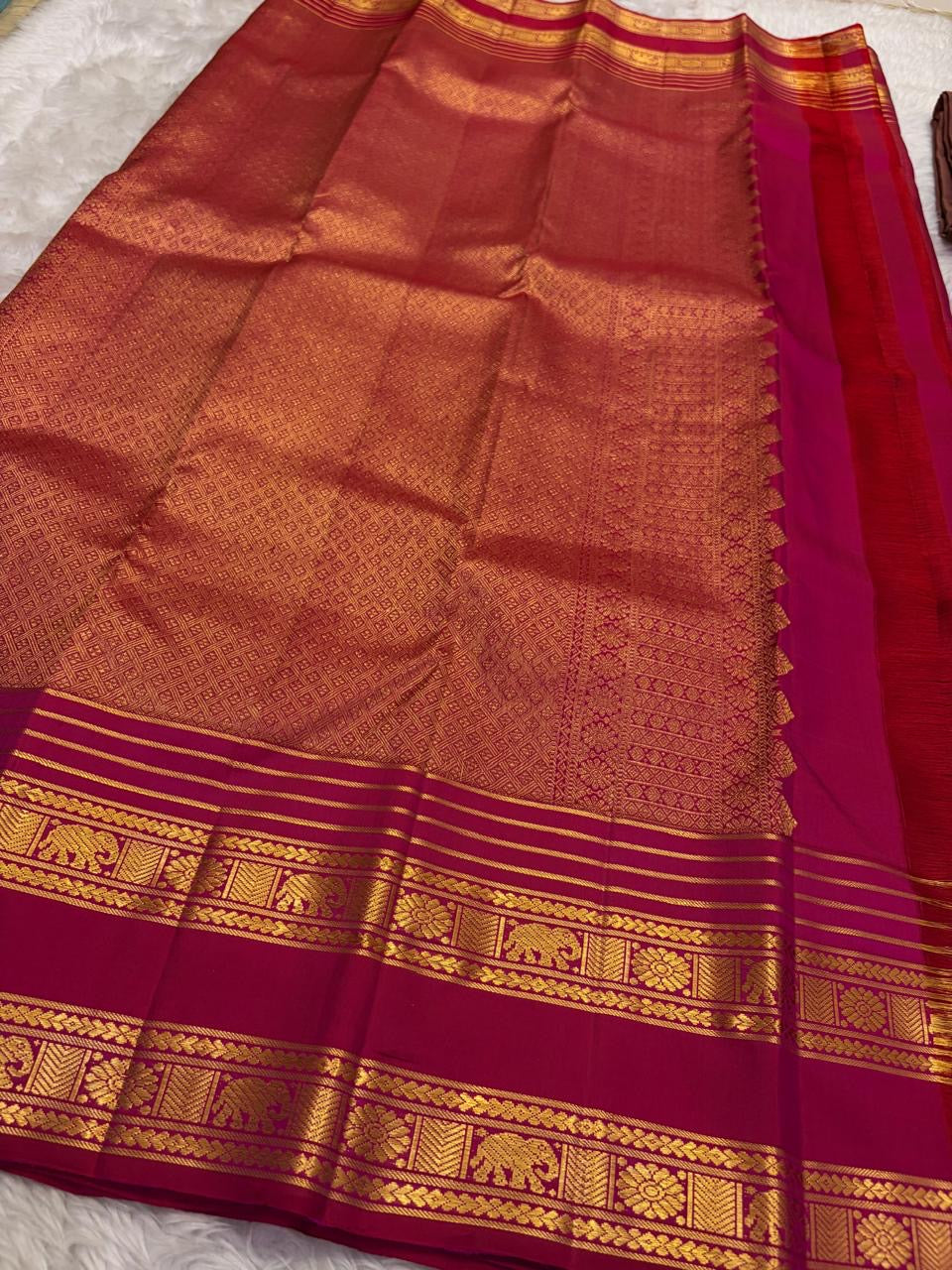 Traditional Yanai elephant border in antique gold on Pomegranate Pink Kanjivaram saree.