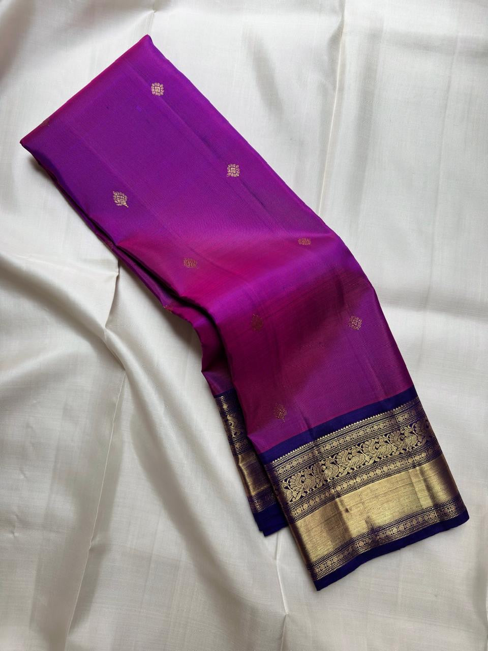 Vadamalli Magenta-Purple Pure Silk Kanchipuram Butta saree with traditional gold zari buttas.