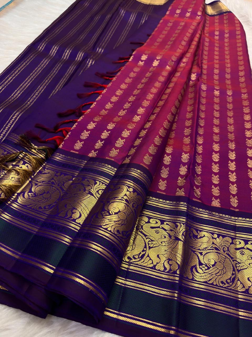 Vadamalli magenta Pure Silk Kanjivaram saree draped, showing zari-woven Gandaberunda motifs