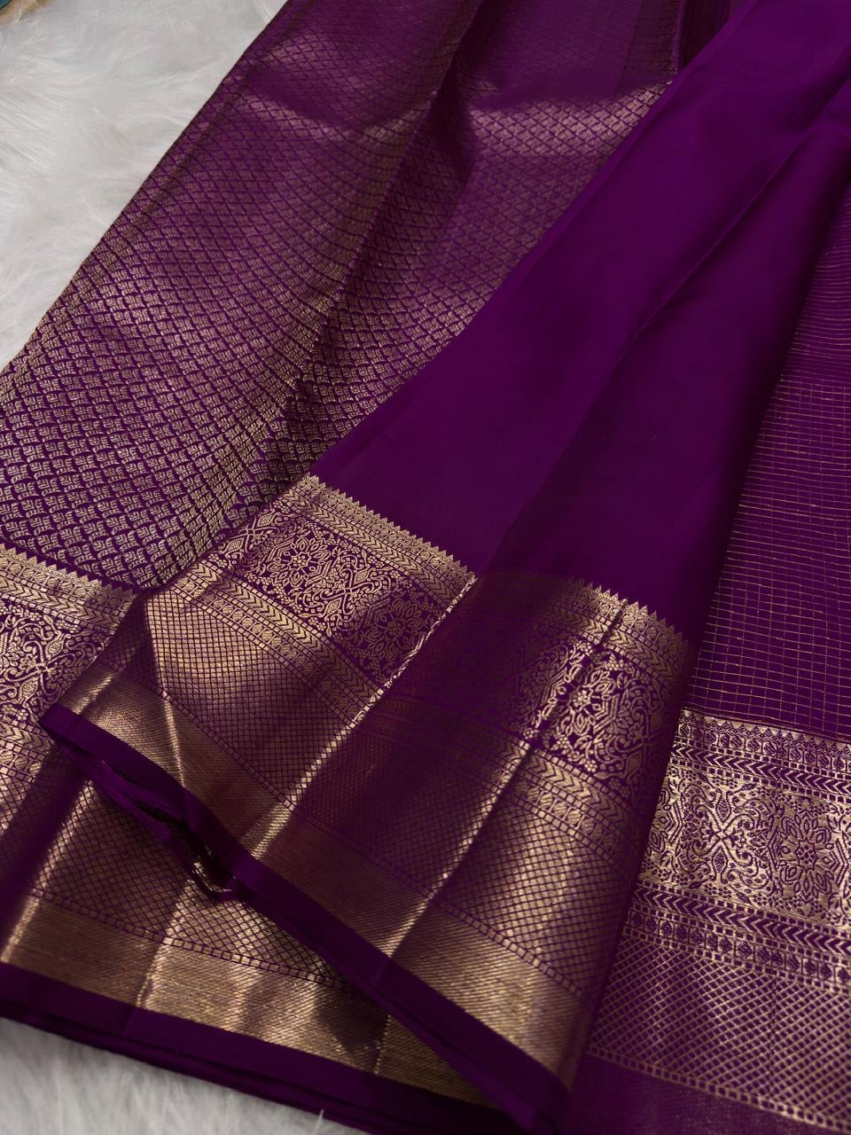 Traditional antique-gold floral butta on Vadamalli Purple Kanjivaram silk.