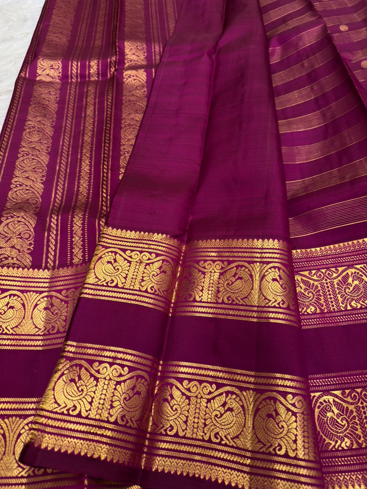 Purple Kanjivaram pallu with repeated zari bands and traditional peacock detailing