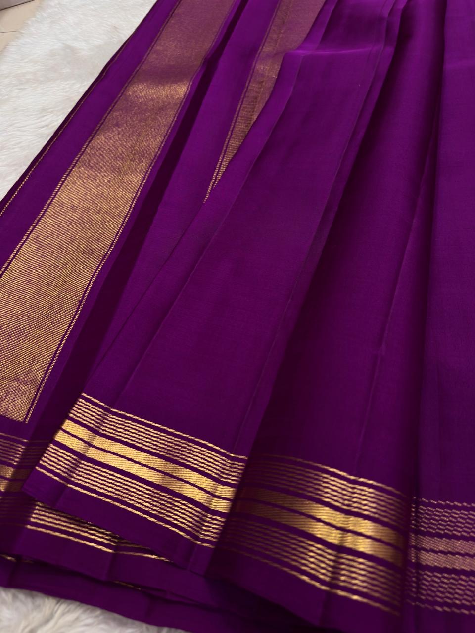 Saturated purple silk body showing individually spaced small classic-gold zari buttas.