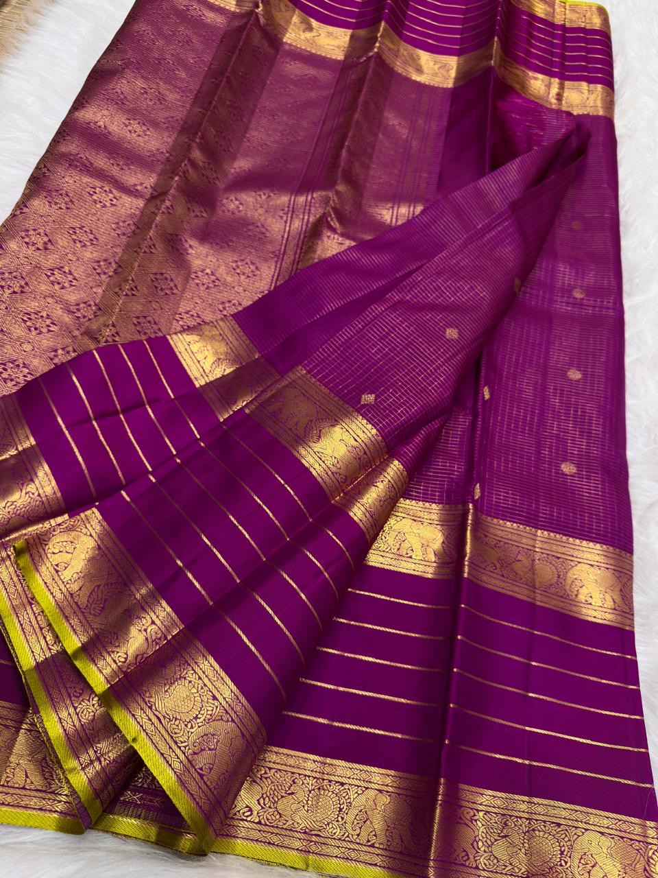 Magenta purple Kanchipuram silk saree with fine gold checks and spaced zari motifs.