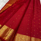 Folded red silk body showing petite gold buttas and richly woven Varisaipet border
