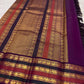 Close view of Deep Aubergine Varisaipet border with green, orange and repeated elephant zari stripes.