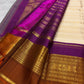 Close view of VarnaJaalam Kanchipuram silk showing ivory zari stripes, purple border and intricate gold bird motifs.