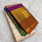 Folded VarnaJaalam Pure Silk Kanchipuram saree showing purple, green, blue and burnt-orange zari borders.