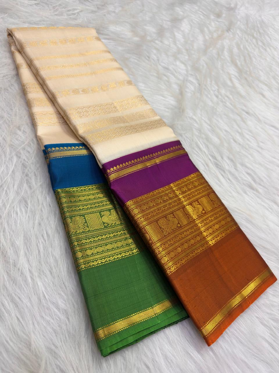 VarnaJaalam Warm Ivory Pure Silk Kanchipuram saree with multiple handwoven zari motif stripes and purple orange border.