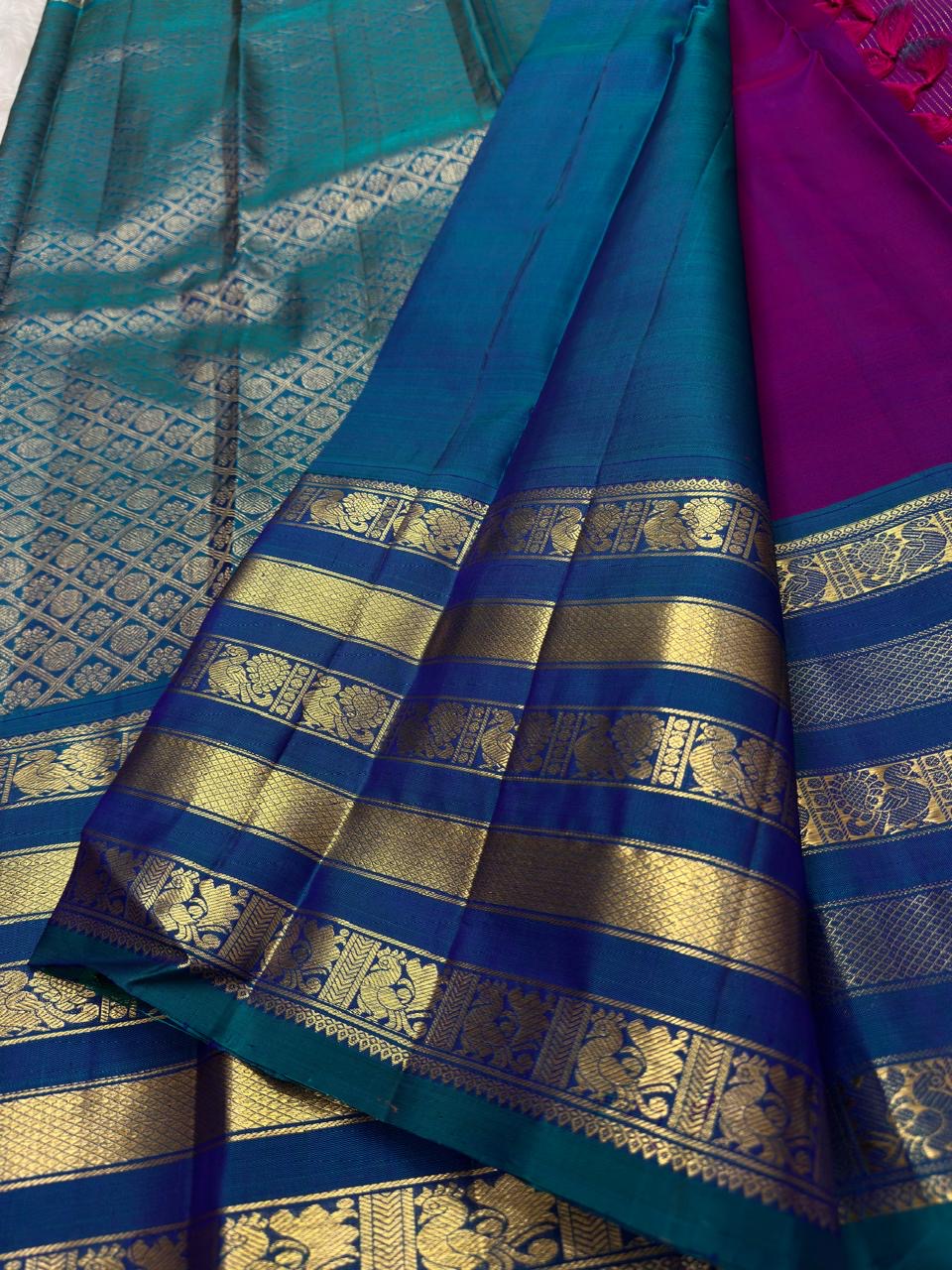 Fine vertical zari stripes across a Vadamalli magenta Kanchipuram silk saree body