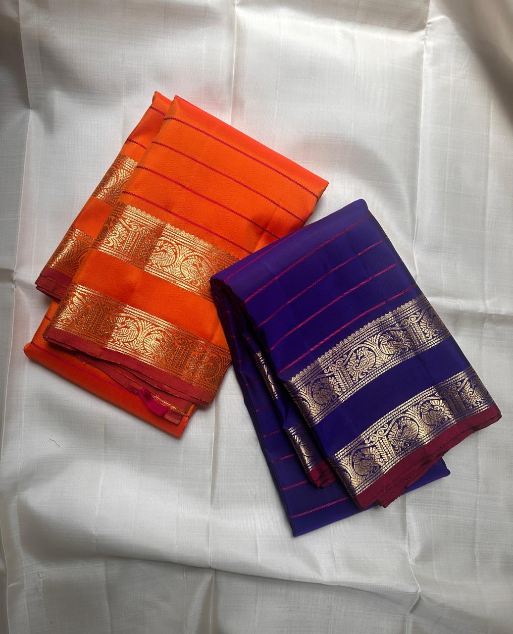 Kanchipattu silk saree in sunset orange with reddish pink border Veldhari Rettapet weave traditional zari detail