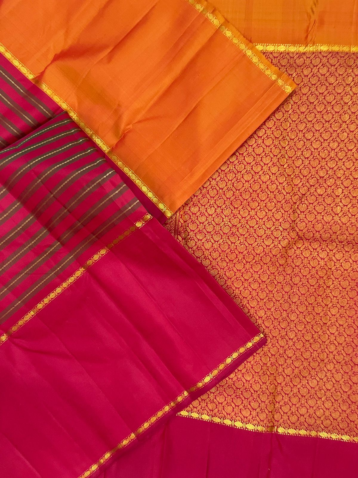 Open Chilli Red Kanchipuram Rettapet saree showing striped Veldhari body, gold zari grid paisley pallu and Ganga Jamuna borders.