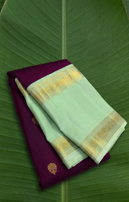 Velvet plum Kanchipuram silk saree with pistachio green rettapet zari border displayed in folded drape view